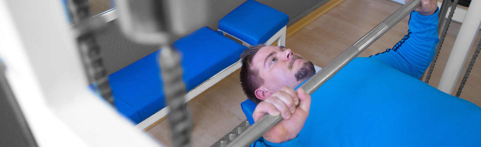 Patient with spinal cord injury paraplegia paralysis after comminuted fracture between thoracic vertebra (TH12) and lumbar spine (L1) during strength training bench press lifting weights