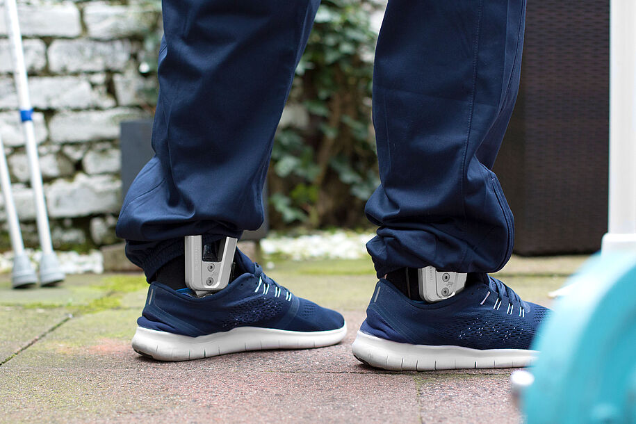 Patient is standing on his legs despite paraplegia. As a supportive device for stabilization, he wears custom-made knee-ankle-foot orthoses KAFOs on both legs, bilateral treatment